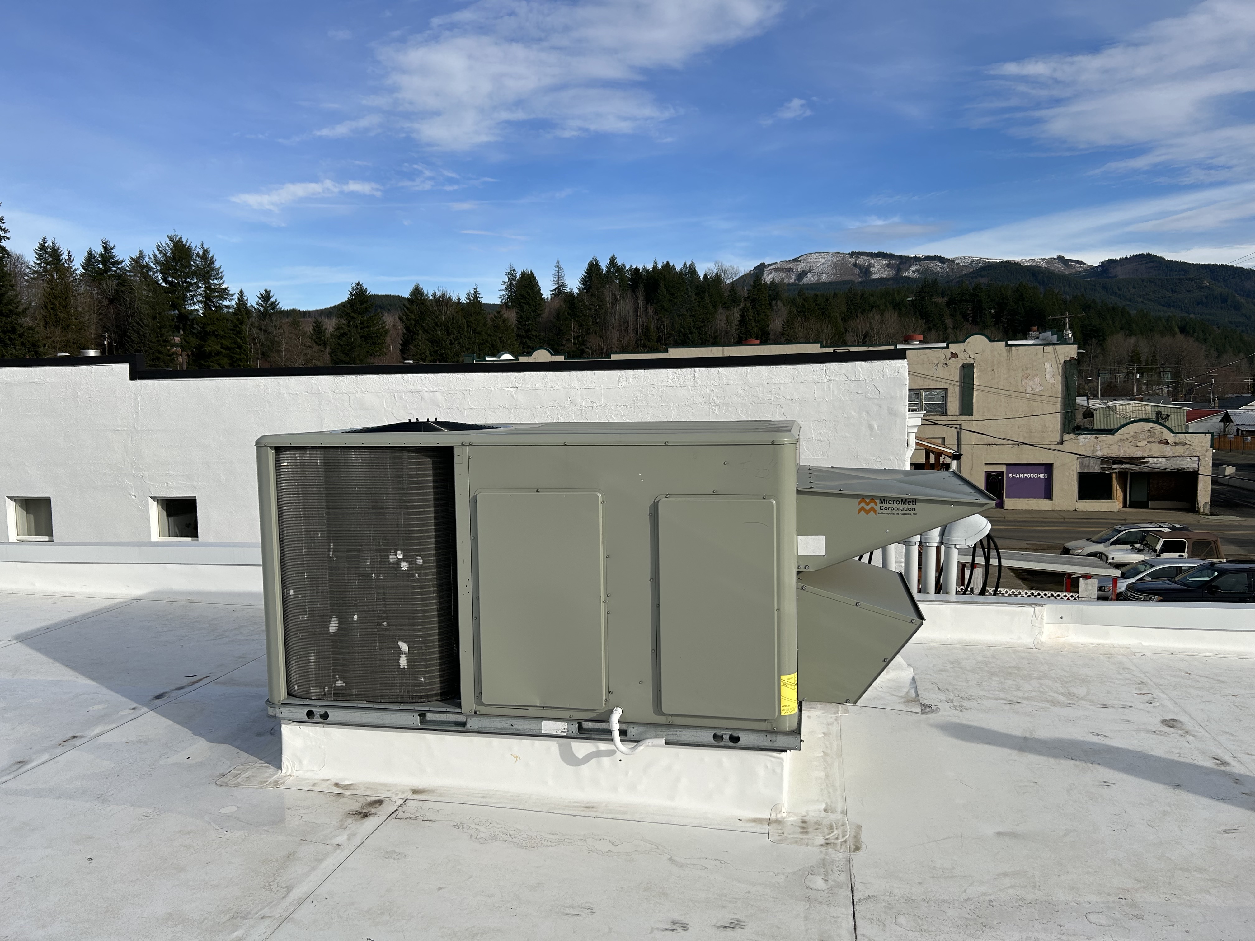 Two new 10-ton heat pumps with interior ductwork and new TPO roofing improve auditorium HVAC
