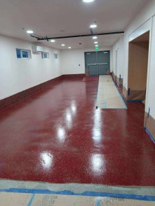 The new epoxy floor finish outside the east stage door to the south doors of the single-level east room.