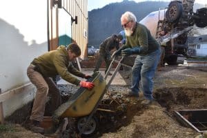 Feb. 5, 2025: Bruce, Brian, and Peter pour a footing wall adjacent to the new Roxy backstage/multipurpose addition to help support the new breezeway that will connect the Roxy to the Tiller.