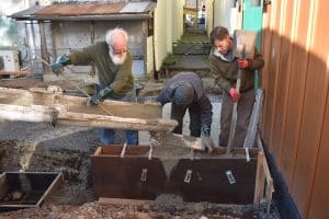 Feb. 5, 2025: Bruce Roberts leads construction of the breezeway designed to connect the Tiller Arts & Events Center to the Roxy Theater. Brian and Peter help him pour the footings.